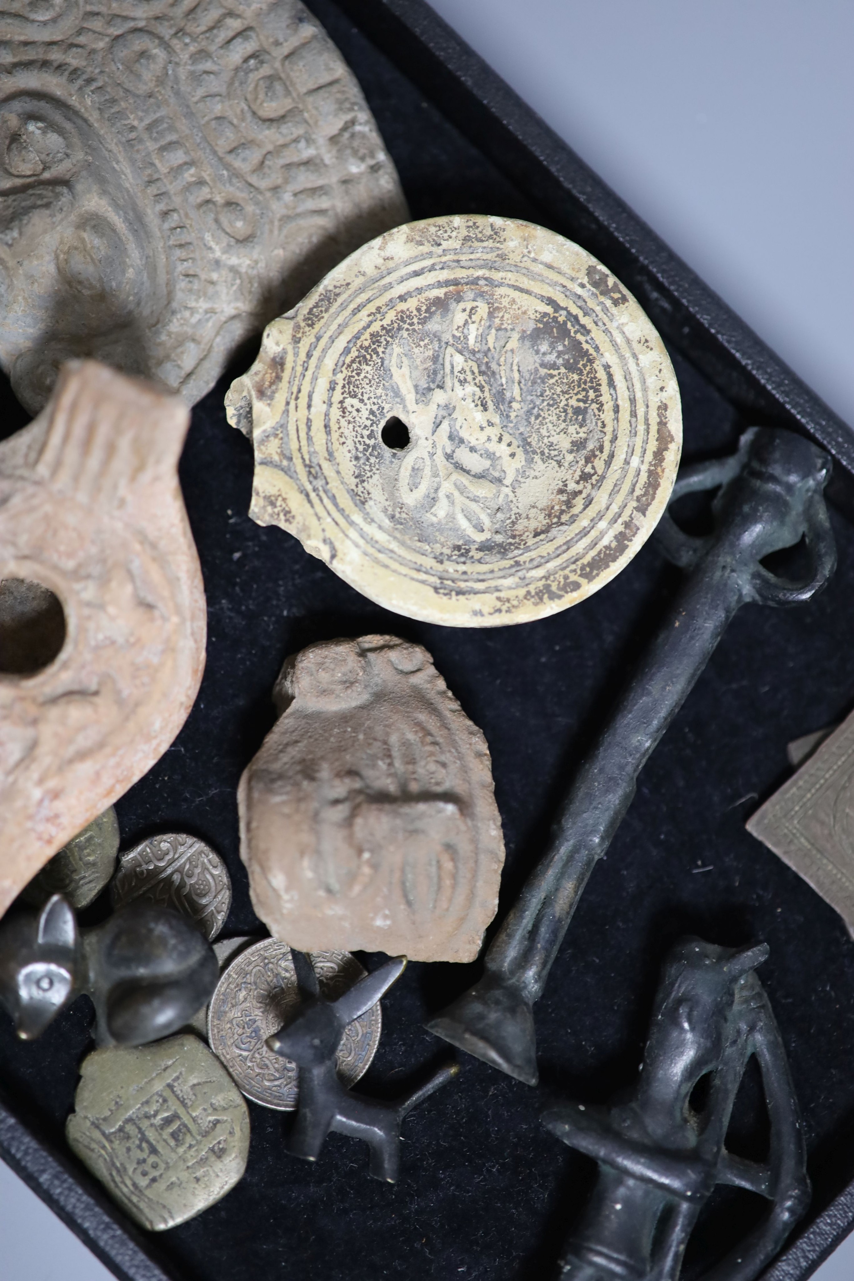 A group of curios including three pre-Columbian pottery fragments, Islamic coins and amulets, etc